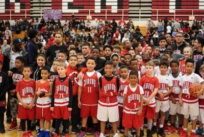 Youth basketball team posing at gym