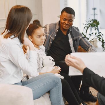 Family attending a therapy session with a counselor.