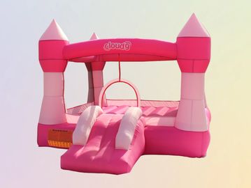 Pink inflatable bounce house with slide and hoop.