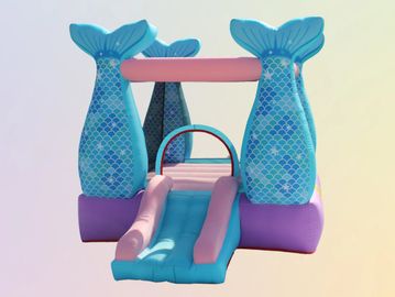 Colorful inflatable bounce house with mermaid tail pillars.
