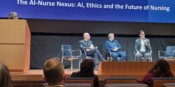 Panel discussion on AI, ethics, and nursing futures at a conference.