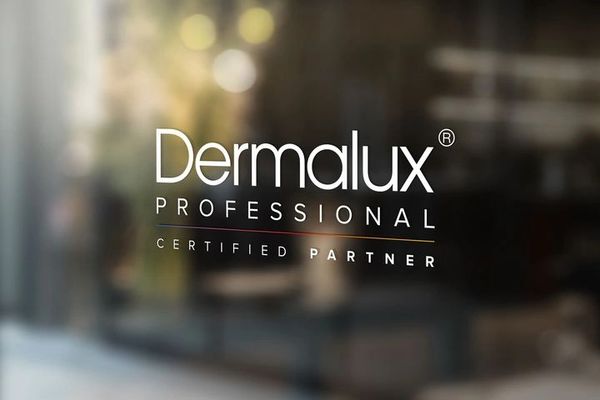 A shop front sign saying Dermalux Professional certified partner