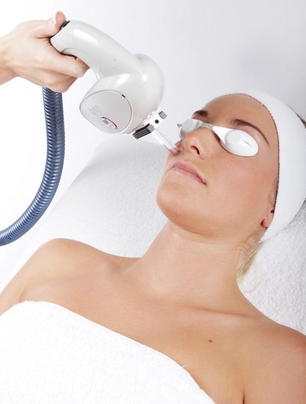 Client laid on clinic couch having IPL treatment