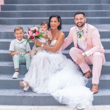 Bride and Groom with their children on the steps of the Don CeSar. 