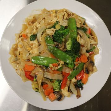 Plate of stir-fried noodles with vegetables and chicken.
