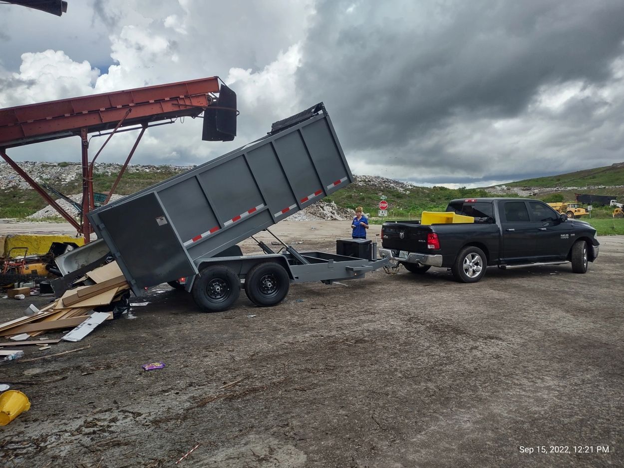 Ashley was unloading our 15-yard dump trailer. 