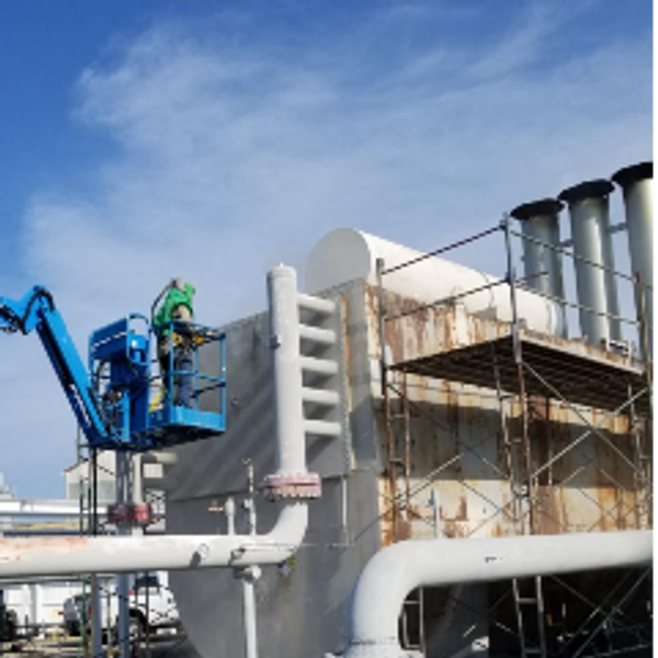 A man doing outside painting on the Tank