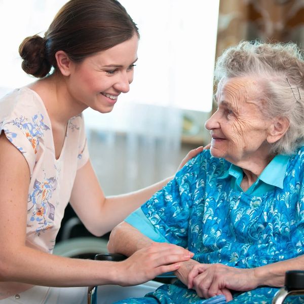 Carer offering company to an elderly woman