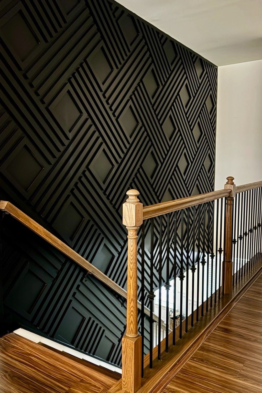 Black geometric accent wall installation with decorative trim by NANDA Trim in Charlotte NC