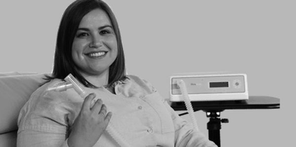 Woman undergoing metabolic testing at home using an indirect calorimetry device.