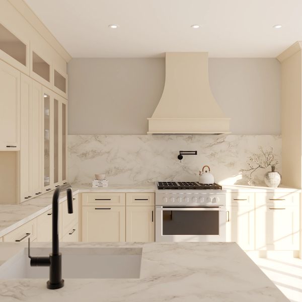 Bright, modern kitchen with beige cabinets and marble countertops.