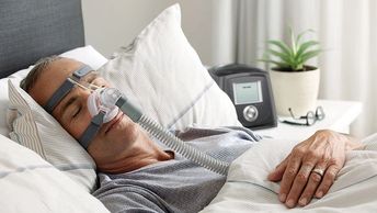 male patient wearing CPAP mask while sleeping