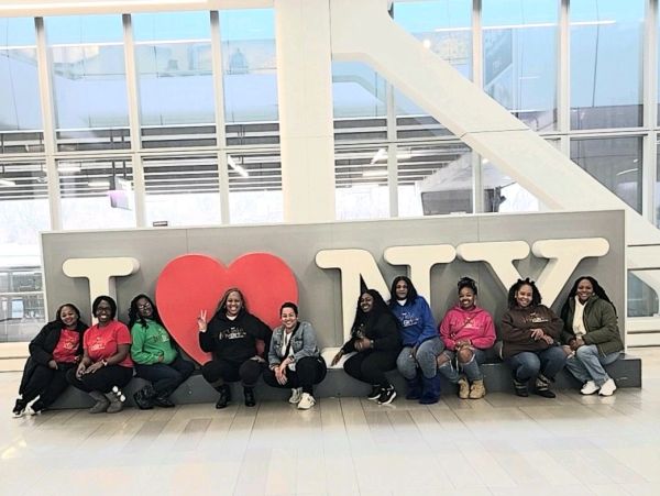 Group of women posing by I love NY sign.