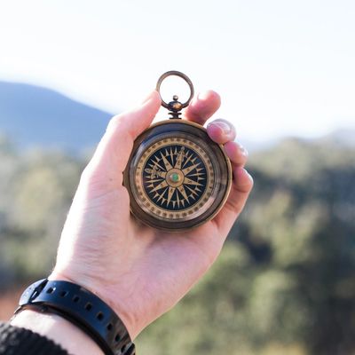 hand holding old old-fashioned compass