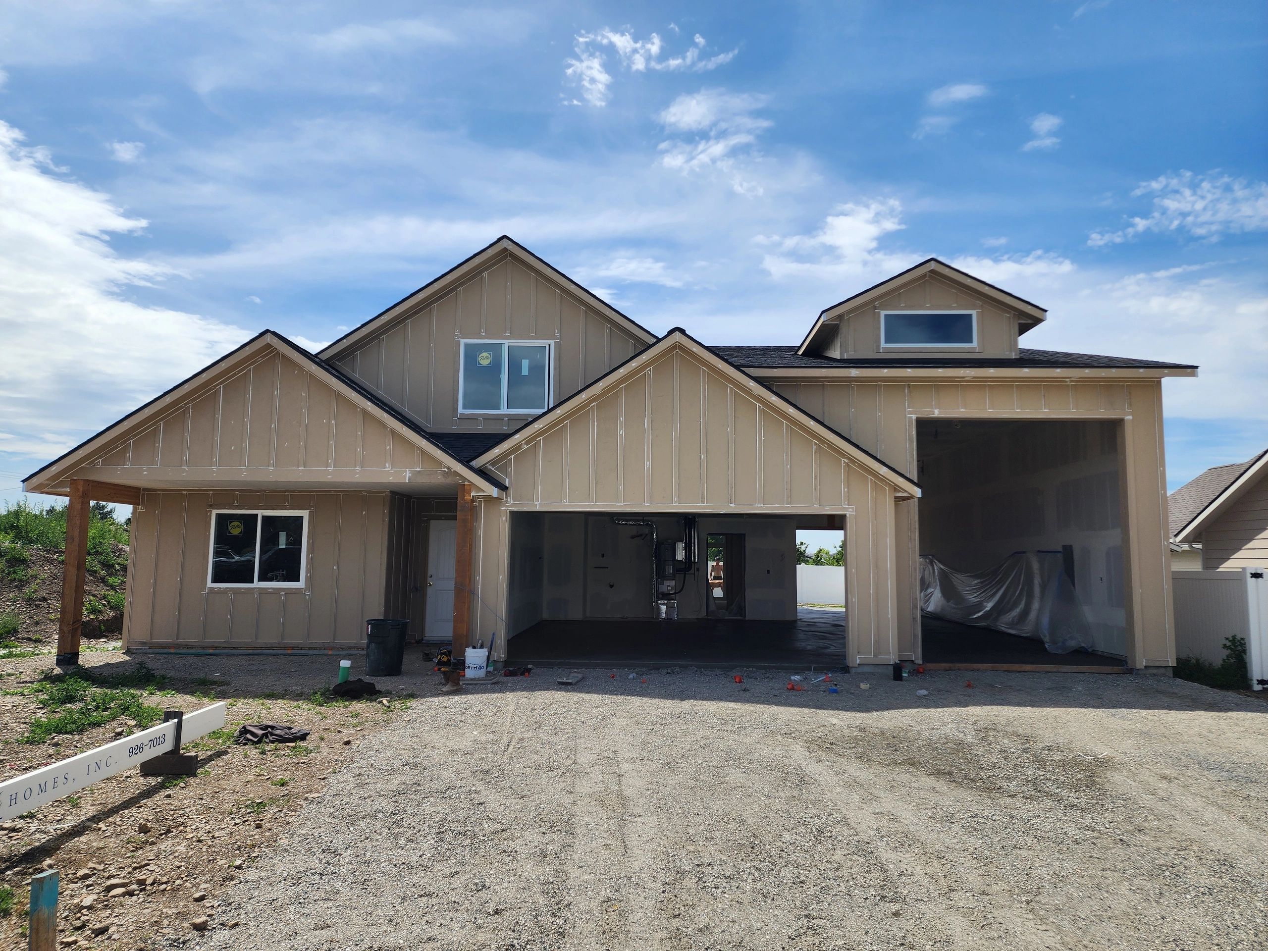New house under construction with a clear blue sky.