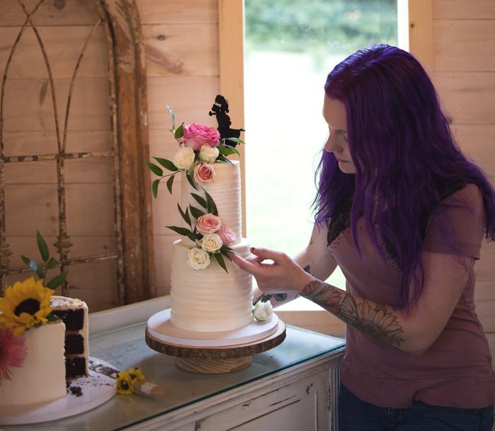 Baker Nicole Ramsey setting up a wedding cake.
Photo provided courtesy of Capturedbyceleste.com