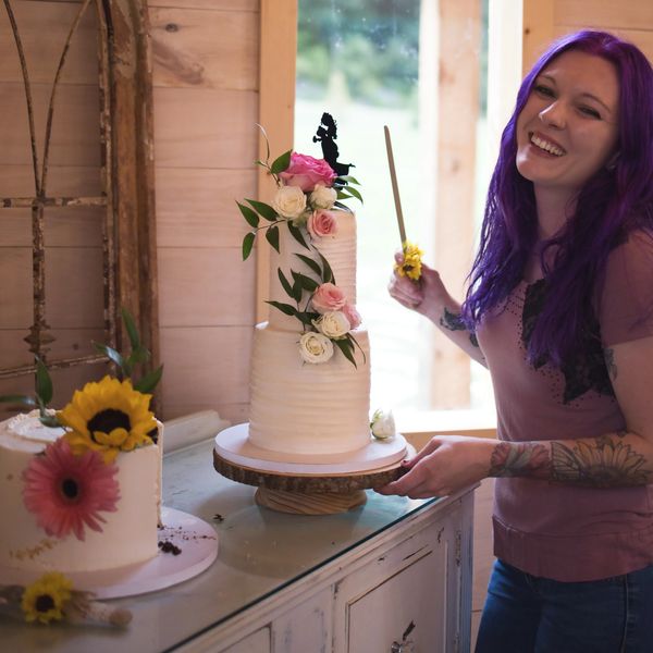 Baker Nicole Ramsey with a cake from Wild Vines Bakery -photo Courtesy of Capturedbyceleste.com