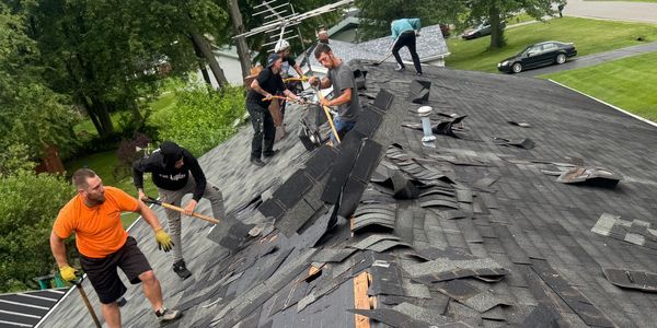 Guys just starting the tear off of the old roof system.