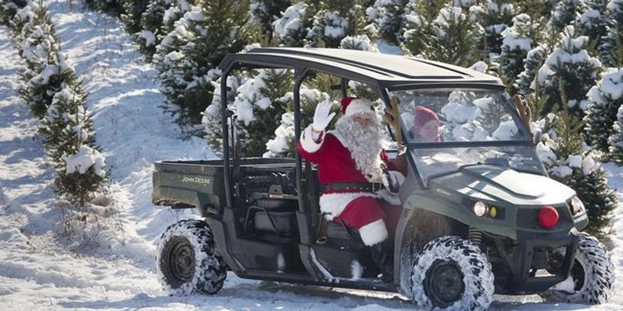 Santa Claus waving hello from our Christmas tree fields covered with snow 