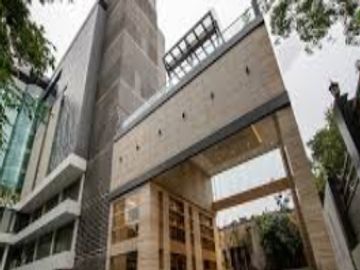 Modern multi-story building with glass and concrete design.