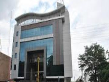 Modern multi-story office building with glass and concrete facade.