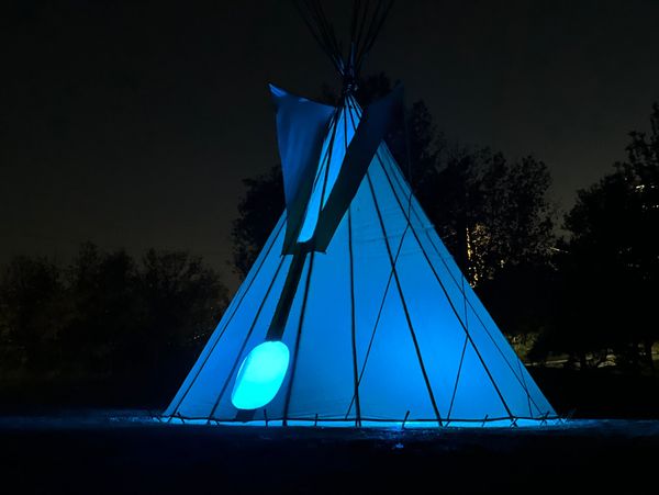 A tipi illuminated in Blue lights