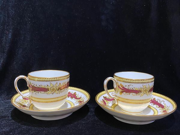 A pair of English Davenport porcelain coffee cups and saucers made between 1870 and 1886 in yellow p