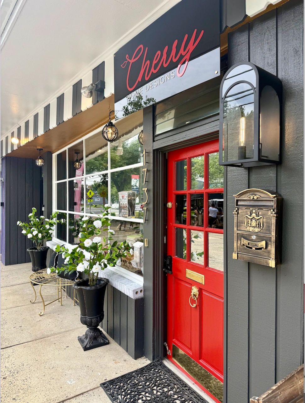 Entrance of Cherry Home Designs with a red door.