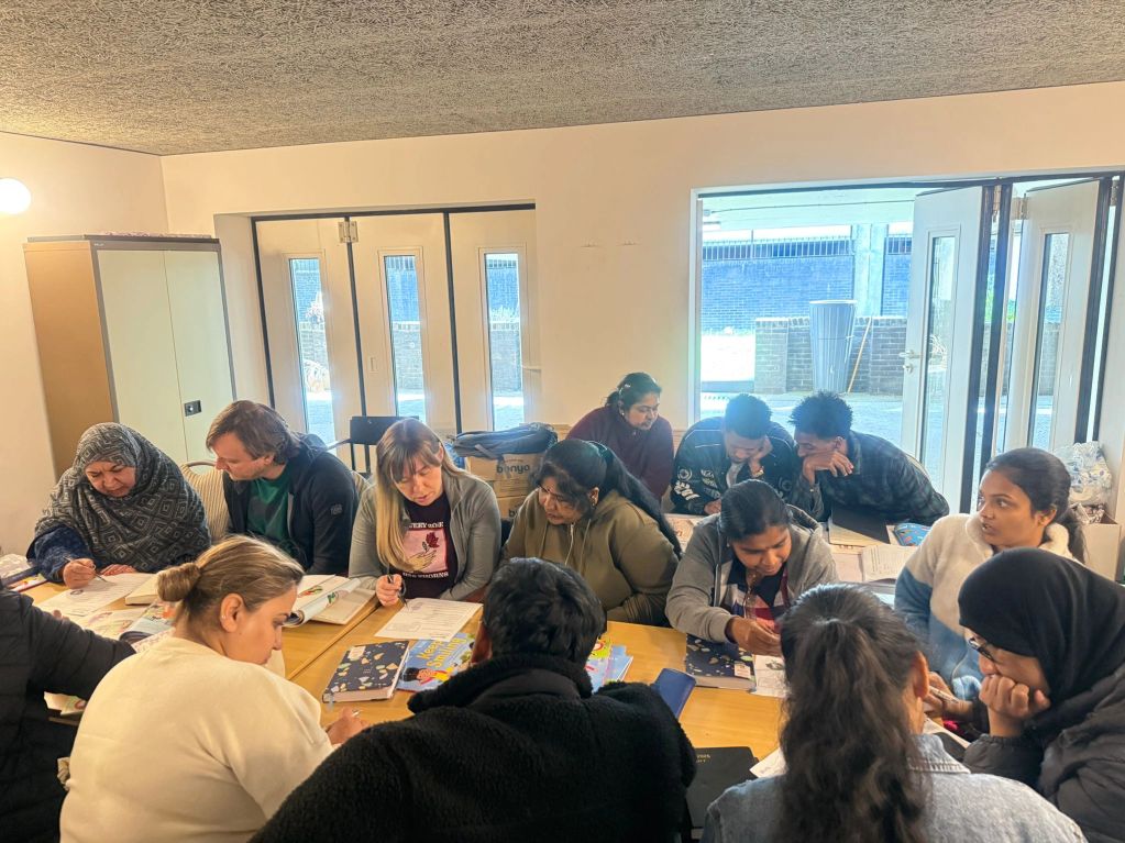 A diverse group engaged in a collaborative study session around a table.