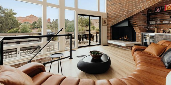 Cozy living room with leather sofas and fireplace.