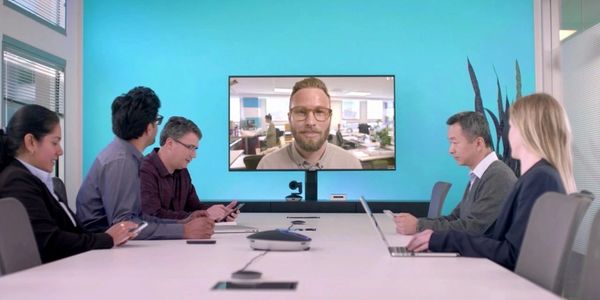 Business team in a meeting room with a video conference call.