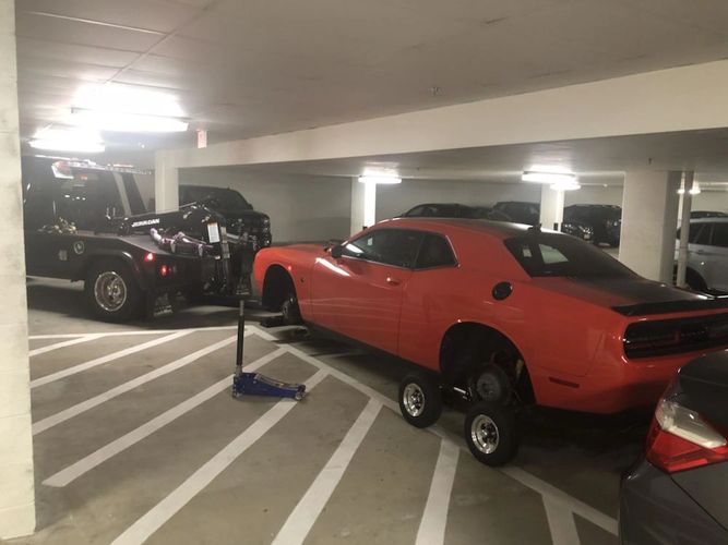 Towing a car out of a garage in Fairfax, Virginia special equipment dollies low clearance tow truck