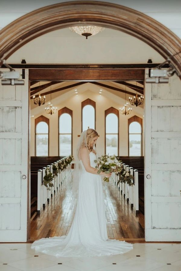 beaming bride in chapel doorway