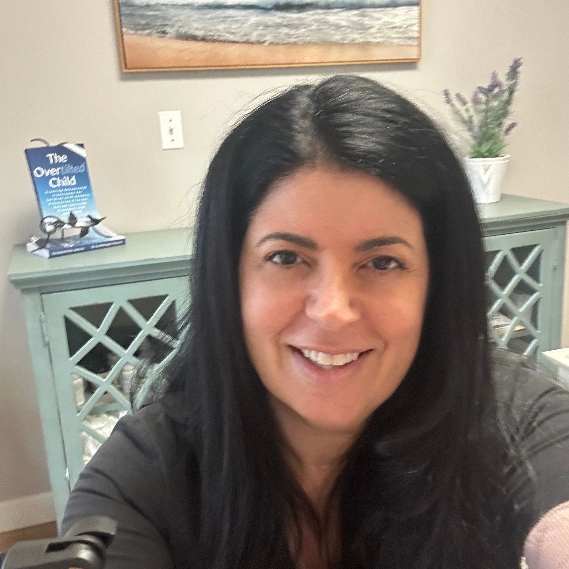 Smiling woman taking a selfie indoors.