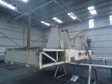 
The image shows a large, industrial metal structure, appearing to be in a state of fabrication