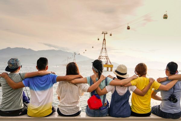 Bilingual mobile notary and loan signing team standing outdoors, united in professionalism and trust