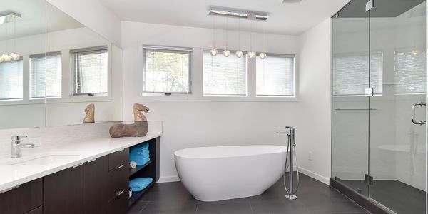 bathroom renovation calgary. Free standing tub. White bathroom. walk in shower. elevated. 