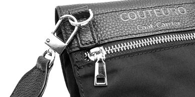 Close-up of a black coat carrier bag with zipper and strap.