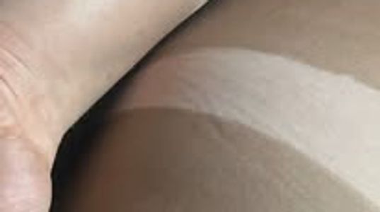 Close-up of a foot and leg with a distinct tan line.