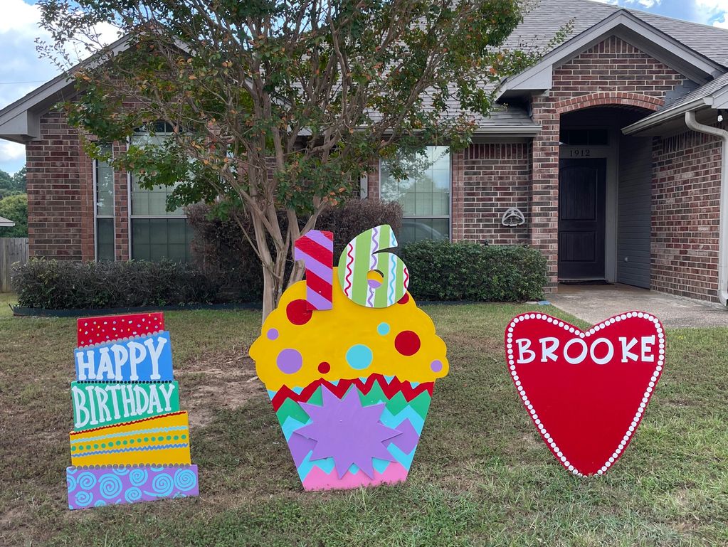 Colorful birthday signs in a yard for Brooke's 16th birthday.