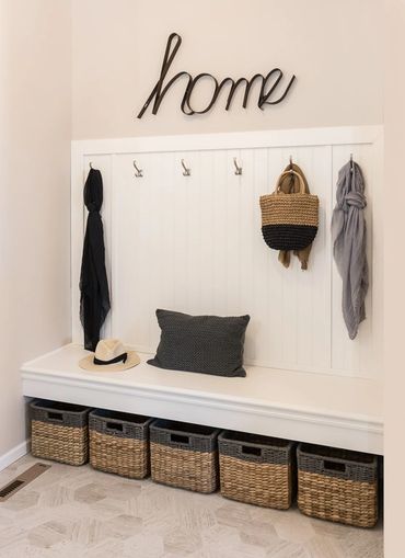 Seating bench with underneath storage, bead board, and coat hooks.