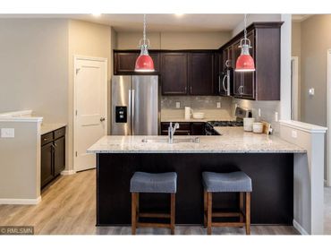 Lovely kitchen with stainless steel appliances and solid surface countertops.