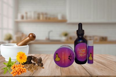 A set of natural wellness products and herbs on a kitchen counter.