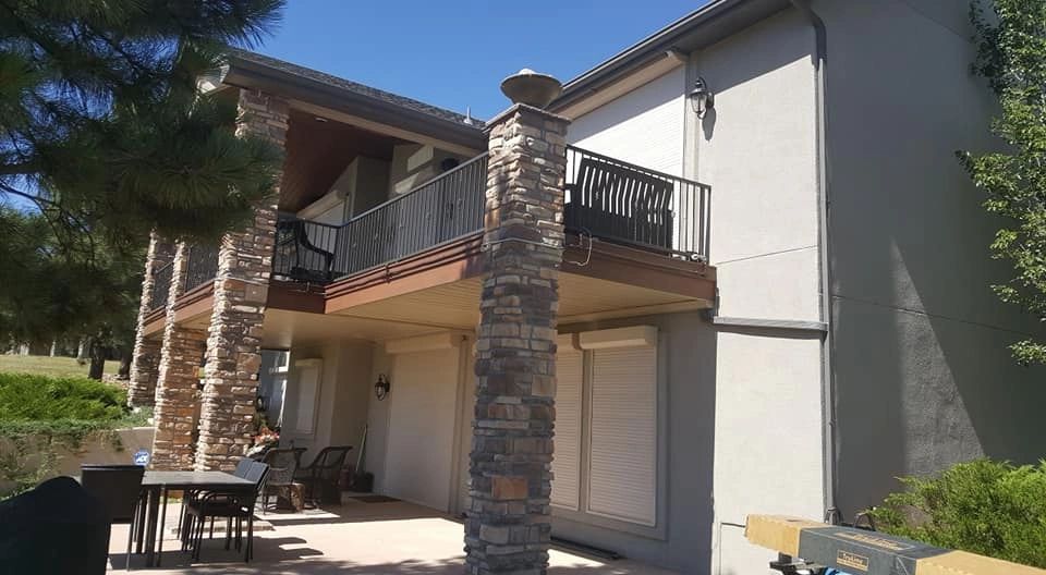 Golf course home with shudders and underdeck ceilings. 