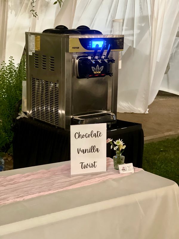 Soft serve ice cream machine with chocolate, vanilla, and twist flavors.