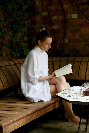 Portrait of woman in white linen pyjamas