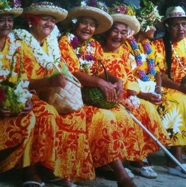 Group of women in same outfit wearing flowers