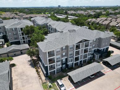 Aerial view of a gray apartment complex.
