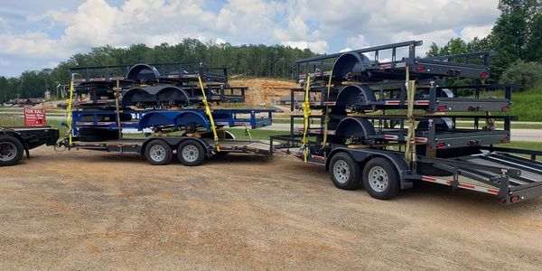 trailers stacked and being towed