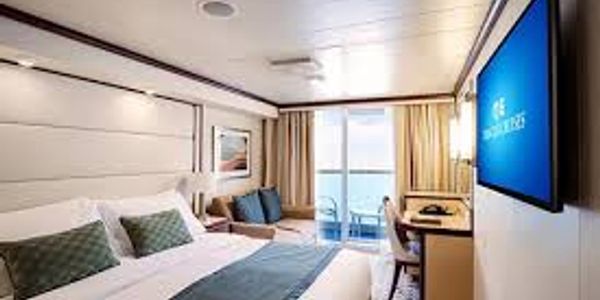 Modern hotel room with ocean view balcony.